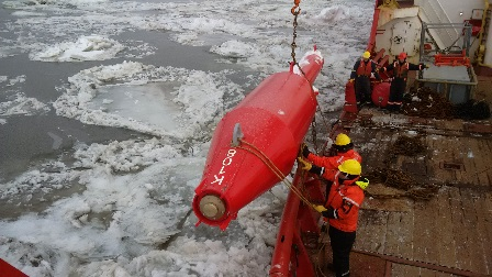 Four-season buoy being lowered into the St. Lawrence river.